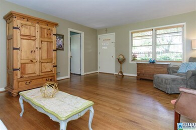 Front door entry into large living room with hardw