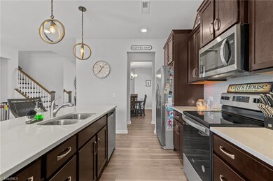 Spacious kitchen has solid surface countertops