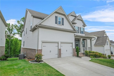 Craftsman-style house featuring brick siding, concrete driveway, a garage, and a front lawn