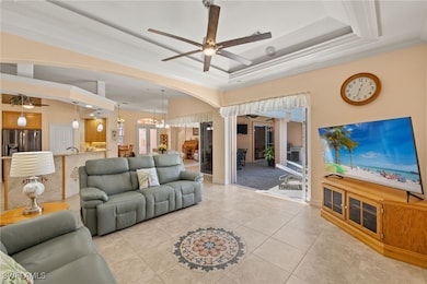 Living area with ornamental molding, a tray ceilin
