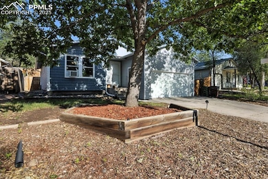 View of front of property featuring concrete driveway and a garage