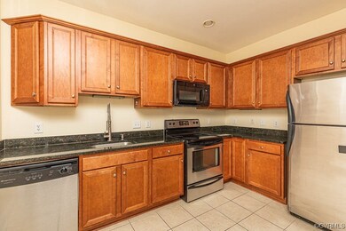Kitchen with sink, stainless steel appliances, lig
