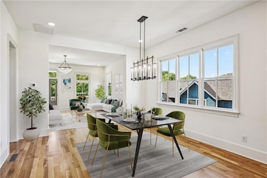 Dining room featuring a notable chandelier and lig