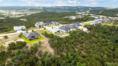 Aerial overview of property's location with nearby suburban area and a forest