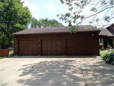 Three car garage with lots of extra storage areas 