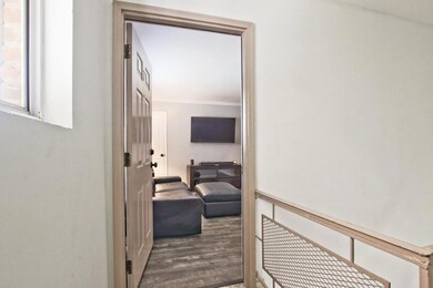 Hall featuring wood finished floors and ornamental molding