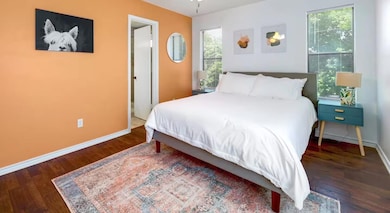 Bedroom with baseboards and wood finished floors