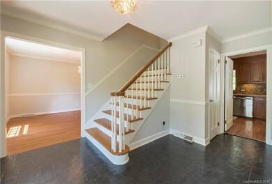 Entry-way with slate floors leading to formal livi