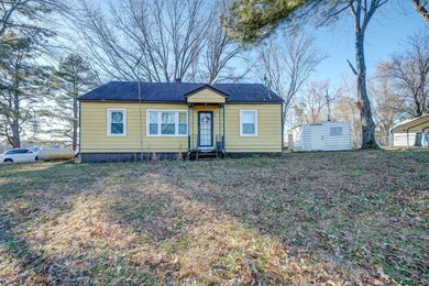 View of front of home featuring a storage shed