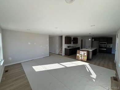Kitchen with a center island with sink, hanging li