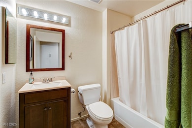Bathroom with vanity, shower / bath combo with sho