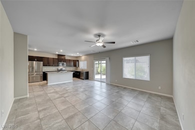 Unfurnished living room with light tile patterned floors, ceiling fan, and recessed lighting