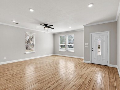 Entrance foyer with baseboards, visible vents, a c