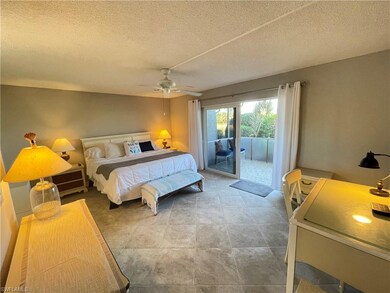 Bedroom featuring access to exterior, a textured c