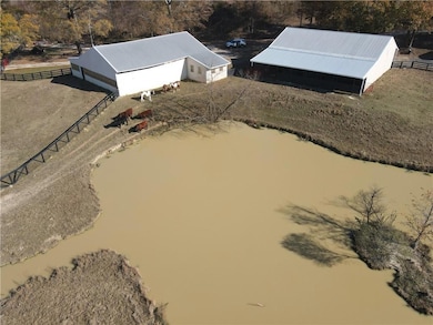 Bird's eye view with a water view of spring fed lake.  Muddy because the cows and horses dive right in