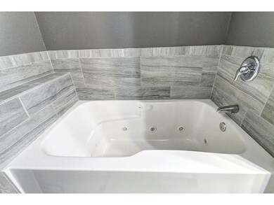 Enjoy a whirlpool bath in the huge bathroom suite.