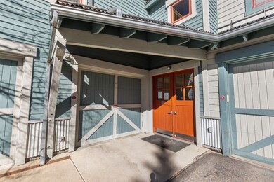View of exterior entry with a garage, a patio area, and french doors