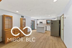 kitchen with a kitchen island, recessed lighting, light countertops, light wood-style floors, and tasteful backsplash