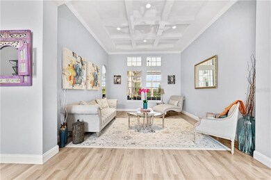 Living room with tray ceiling and overlooking pool