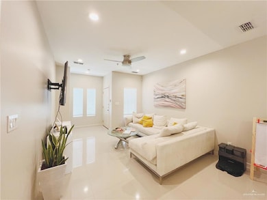 Living room with light tile patterned flooring, ceiling fan, and recessed lighting