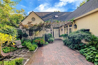 Courtyard leads to the front door, and a door to the left leads to the breakfast area and kitchen