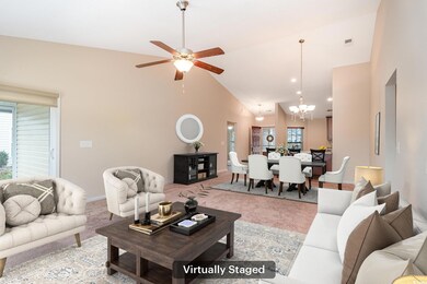 Living area with ceiling fan with notable chandeli