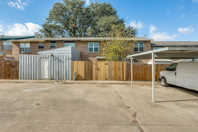 View of front of home with a gate and brick siding