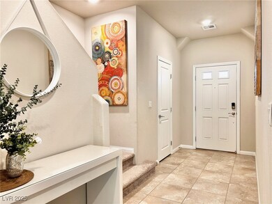 Foyer with stairs, light tile patterned flooring,