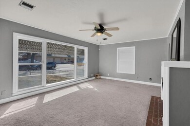 Unfurnished living room with dark colored carpet, 