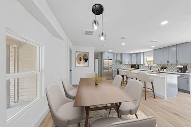 View of Dining and Kitchen area- Virtually staged 
