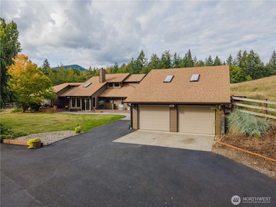 Abundant parking & extra deep 2 car garage with workspace & storage loft.