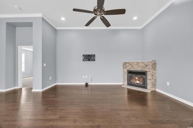 Unfurnished living room featuring crown molding, a