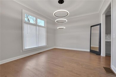 Empty room with ornamental molding and dark wood-t