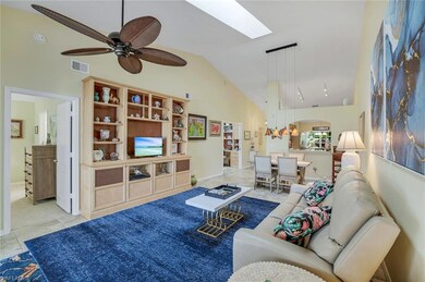 Living room featuring a skylight, arched walkways,