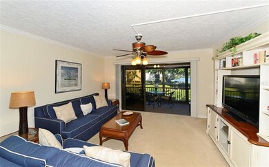 Living room with sliders to enclosed balcony