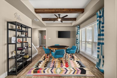 Playroom with wood finished floors, beamed ceilin