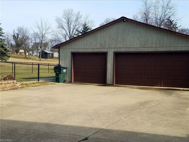 Check out this cement drive area and 3 car garage 