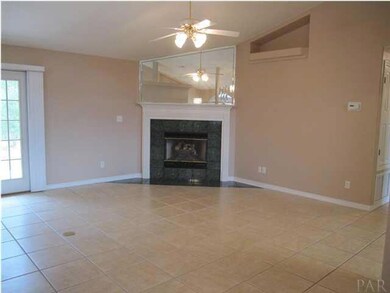 Family room has natural gas fireplace with tile hearth. Plant ledge is lighted. Notice the floor outlet to your left. French door to your left leads to the open patio.