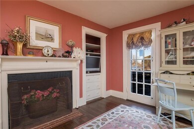 Built-ins and French door that leads...