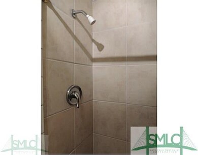 Exterior Front. Ceramic tile walk-in shower in mas