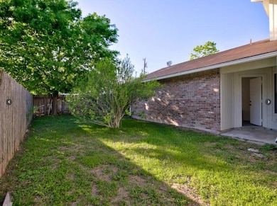 Fenced backyard with a patio area
