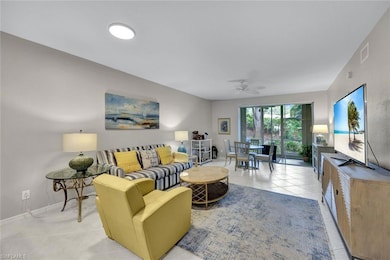 Tiled living room featuring ceiling fan