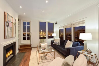 The living room has a wood-burning fireplace and splendid views of downtown.