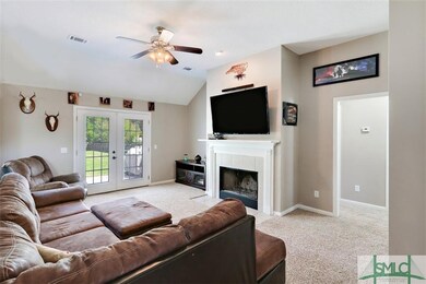 Great room with fireplace and french doors leading