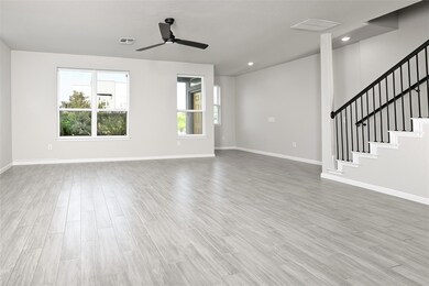 Unfurnished living room featuring ceiling fan, pl