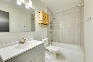Bathroom with toilet, vanity, and shower / bathtu