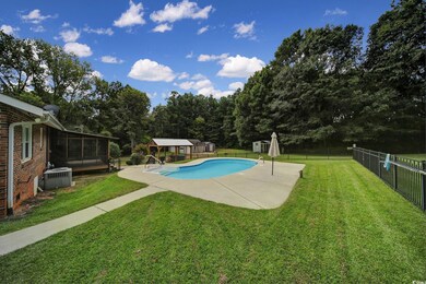 View of swimming pool with a sunroom, a lawn, a st