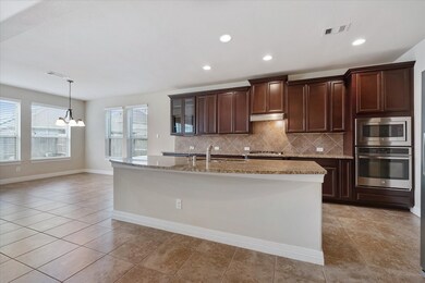 Featuring rich high/low cabinetry, sleek stainless