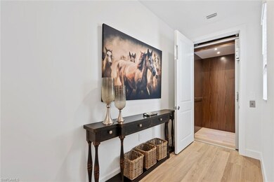 Hall with light hardwood / wood-style floors and e