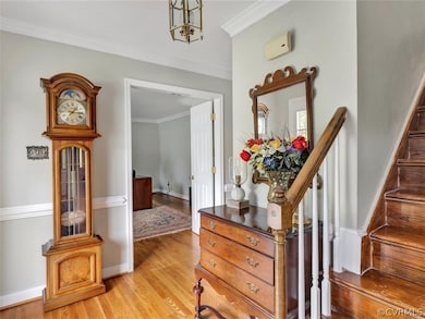 The foyer boasts hardwood floors, crown molding and chair railing. To the left is a flex space used as an office and to the right is the formal dining room.